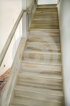 Set of newly built bare wood poplar stairs during home remodel, unpainted, unfinished photo