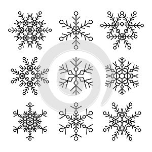 Set of nine vector simple linear snowflakes icons. Hipster black and white design elements.