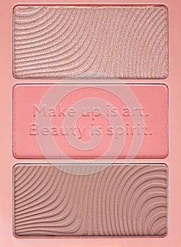 Set of nude pink and peach color eyeshadow in a palette isolated on white background. Highlighter and eyeshadows. Makeup