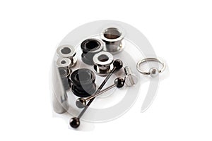 Set of old black and white piercing accessories on white background. Isolate