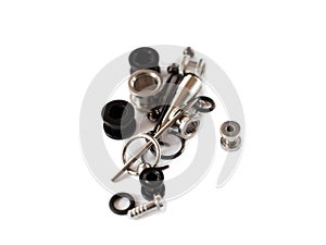 Set of old black and white piercing accessories on white background. Isolate