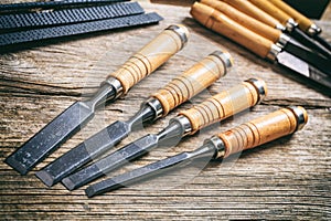 Set of old chisels on a wooden