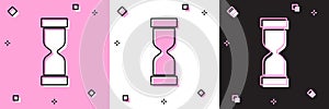 Set Old hourglass with flowing sand icon isolated on pink and white, black background. Sand clock sign. Business and