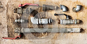 Set of old hydraulic hoses and pipelines on an old wooden board photo