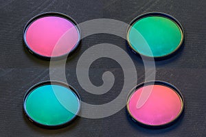 Set of old rotary polarizing filter with stains on dark background