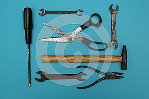 Set of old rusty tools on a blue background