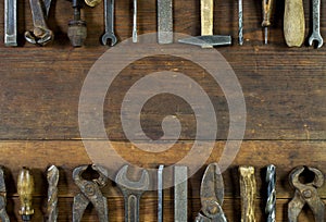 Set of old rusty tools on rustic wooden background