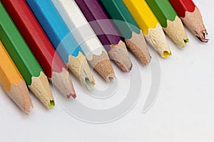 Set of old used and broken colored pencils on a white background. Ugly worn crayons or pencils with broken ends should be