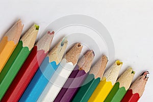Set of old used and broken colored pencils on a white background. Ugly worn crayons or pencils with broken ends should be