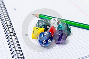 Set of open exercise book, pencil and dices