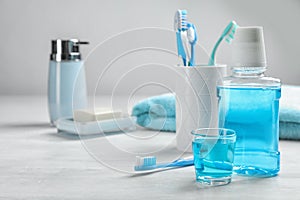 Set of oral care products on light table photo