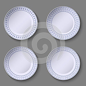 Set of ornamental plates with a blue floral decor in manual style and a blank space in the center.