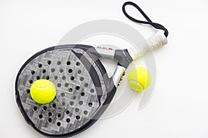 Set of paddle tennis rackets and balls the reflected on white table and white isolated background. Front view.