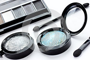 Set pallets with blue and gray eye shadows, brushes for eye make