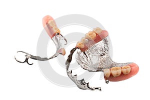 Set of partial metal upper and lower removable dentures on white background