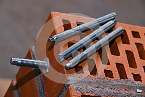 Set of parts for mounting anchors in hollow brick and concrete lie on the surface of the brickwork in any order. Threaded studs