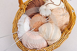 A set of pastel clew of thread for knitting in a basket. Handmade, hobby, crochet concept