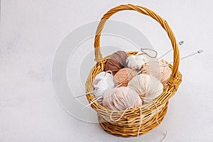 A set of pastel clew of thread for knitting in a basket. Handmade, hobby, crochet concept