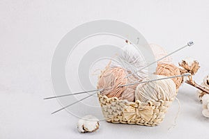 A set of pastel clew of thread for knitting in a basket. Handmade, hobby, crochet concept