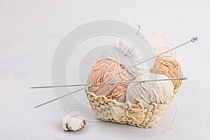 A set of pastel clew of thread for knitting in a basket. Handmade, hobby, crochet concept