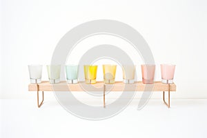 set of pastel colored votive candles in glass holders