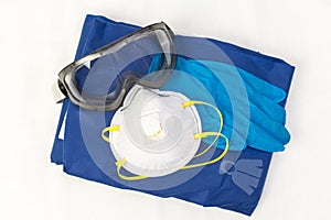 A set of Personal protection equipment against respiratory viral infections. Protective glasses , disposable gloves, suit and an