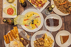 A set of Peruvian food dishes with huancaina potatoes in the center, a