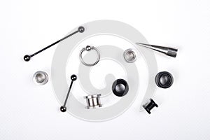 Set of piercing accessories on white background