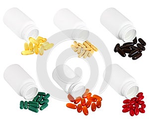 A set of pills spilling out of white plastic medicine bottle.