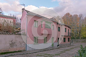 Set of pink cottages with green windows