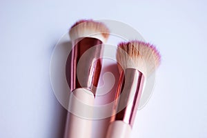 Set of pink and gold makeup brushes professional kit