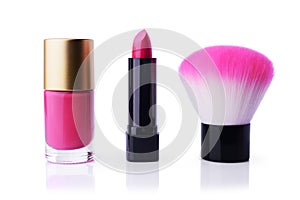 Set of pink nail polish, lipstick and make-up brush