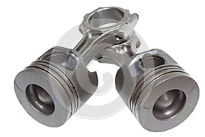 A set of pistons and rods for automobile engine on a white background