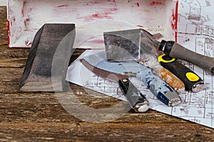 set of plaster trowel tools and spatula on background old wood.