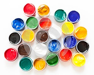 Set of plastic cans with colored paints, white background, top view