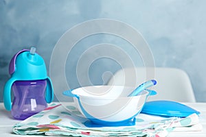 Set of plastic dishware on table. Serving baby food