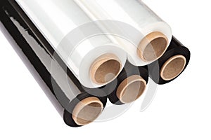 Set of plastic packaging materials - plastic white and black stretch film rolls isolated on white. PE packaging