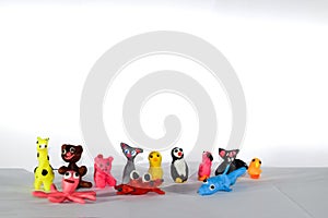 A set of plasticine toys on white background. Toys made of plasticine in the form of animals