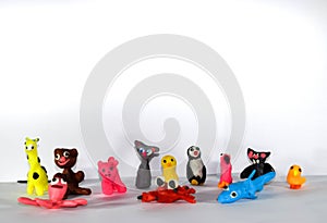 A set of plasticine toys on white background. Toys made of plasticine in the form of animals