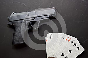 Set of playing cards and gun  on black background. casino concept