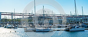 set of pleasure boats moored at the AlcÃ¢ntara docks in Lisbon.