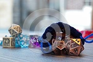 A set of polyhedral dice with a draw string bag