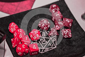 A set of polyhedral dice used for role playing games such as Dungeons Dragons. A fresh classic for 2023 in Viva Magenta