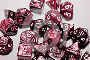 A set of polyhedral dice used for role playing games such as Dungeons Dragons. A fresh classic for 2023 in Viva Magenta