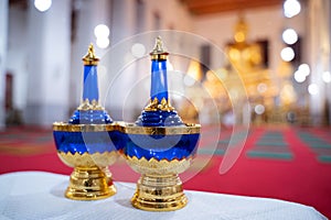 A set pour ceremonial water , bottle for gravel of water pebbles, sapphire blue, placed side by side on the table