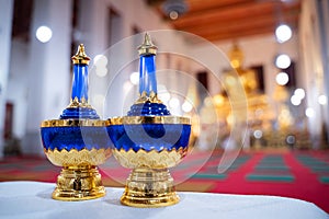 A set pour ceremonial water , bottle for gravel of water pebbles, sapphire blue, placed side by side on the table