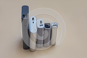 Set of power banks of different sizes on a light background. Choosing a portable charger