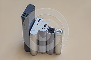 Set of power banks of different sizes on a light background. Choosing a portable charger