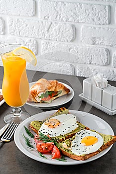 A set of products for a delicious European Breakfast Scrambled eggs, croissants and orange juice