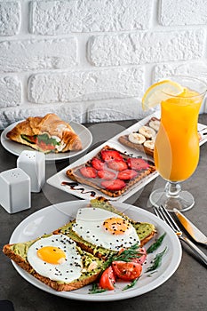 A set of products for a delicious European Breakfast Scrambled eggs, croissants and orange juice